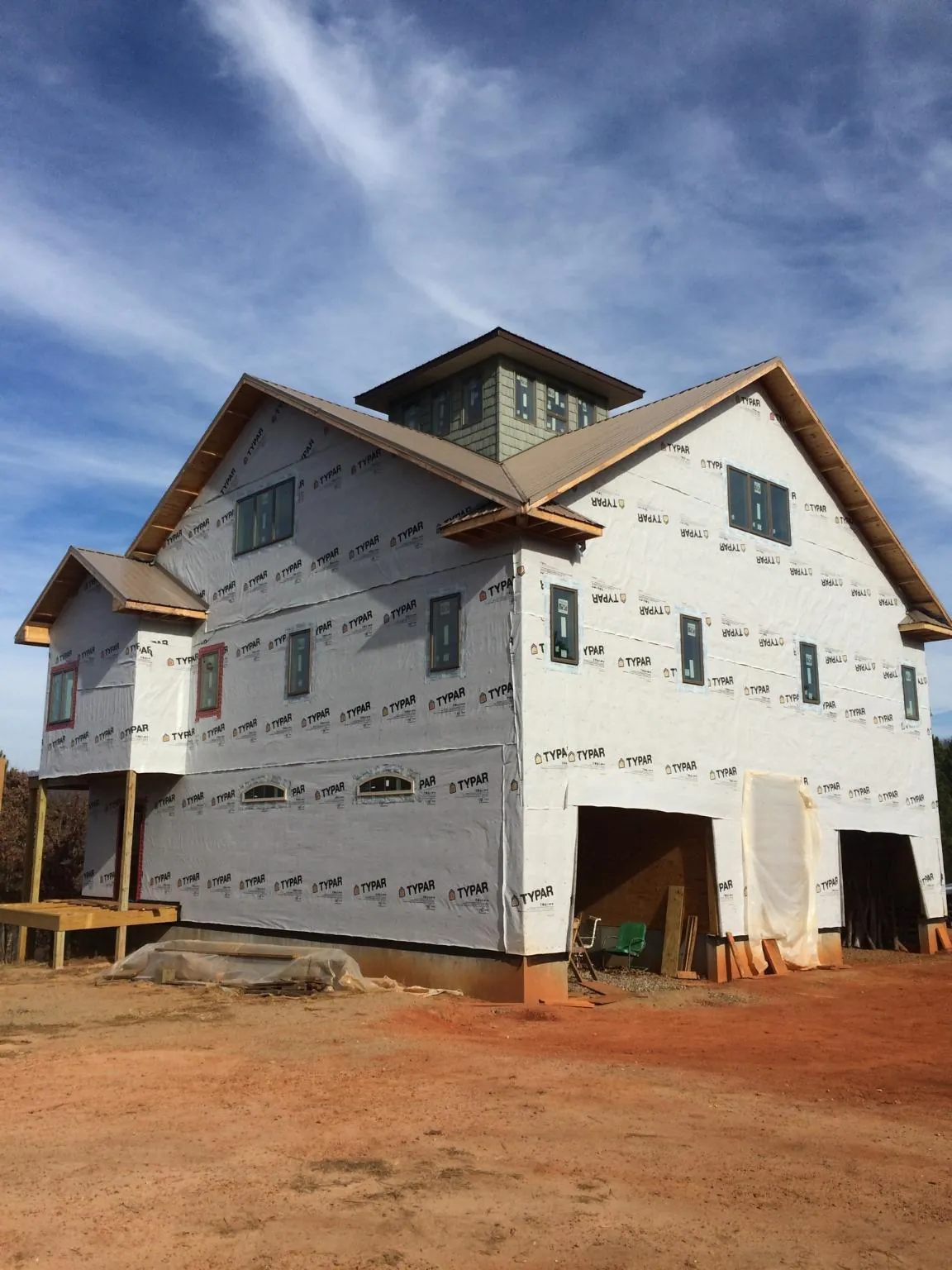 New two story house under construction with a cupola and gabled roofs in Manchester